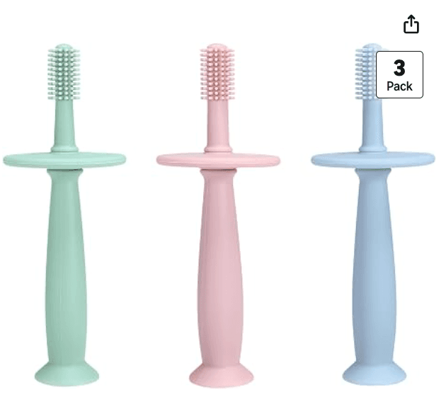 Three small silicone baby toothbrushes in mint, pink, and blue